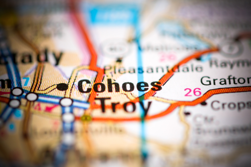 Close-up of a map highlighting Cohoes and Troy in New York with surrounding roads and towns