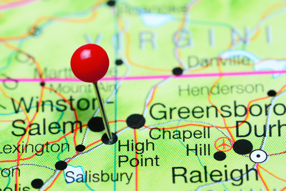 Red pushpin marking High Point on a map of North Carolina with nearby cities Winston-Salem, Greensboro, and Raleigh visible